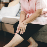 Elderly Woman Sat With Stiff Joints