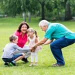Elderly Couple Playing With Grandchildren