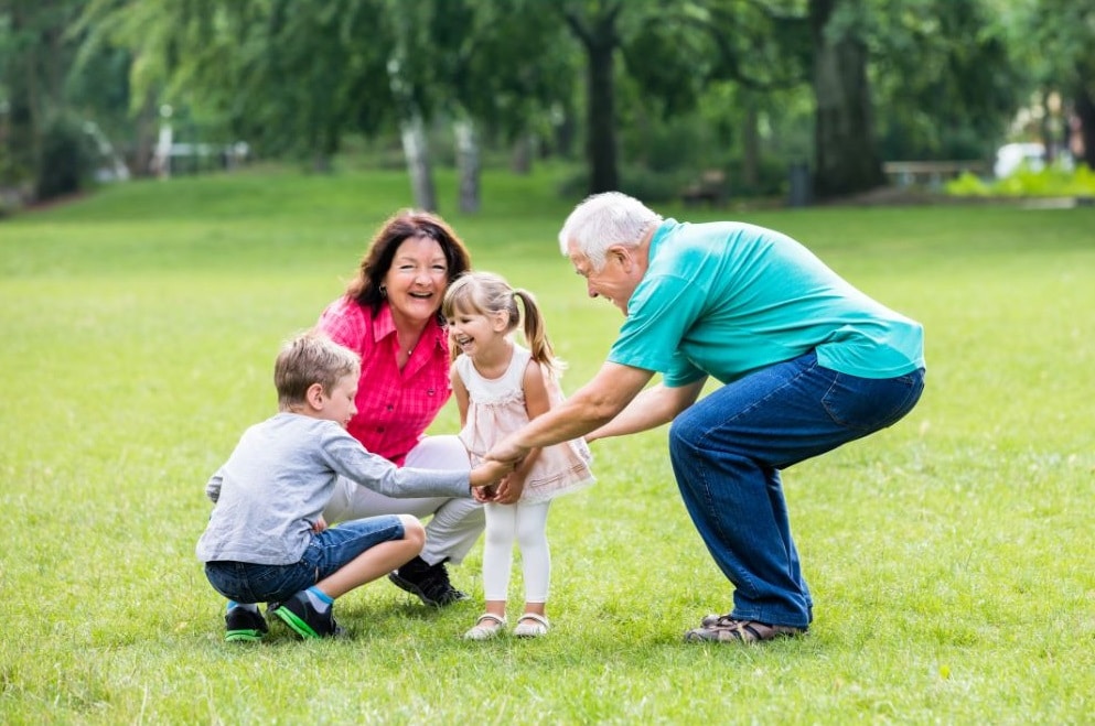 Elderly Couple Playing With Grandchildren